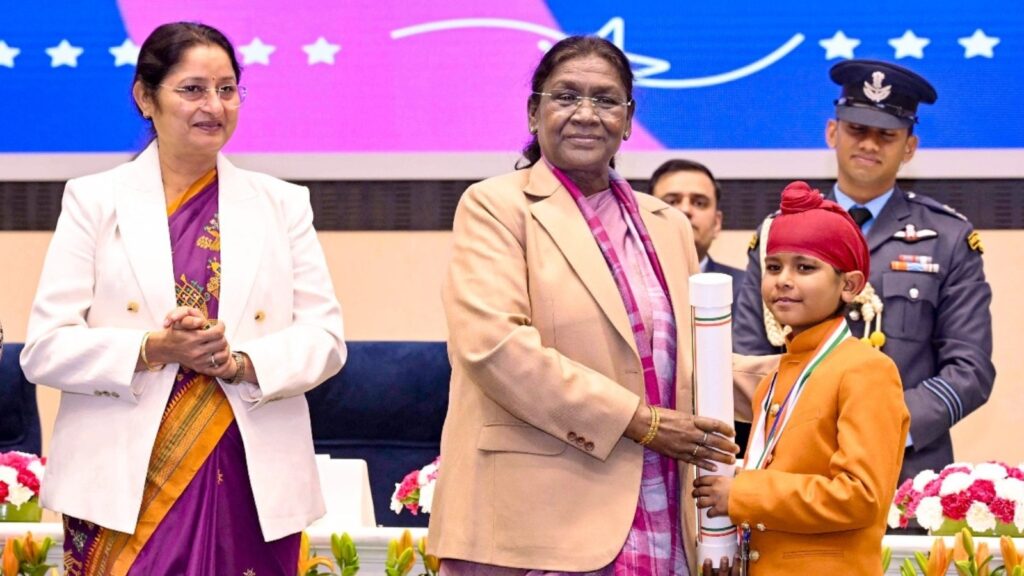 National award ceremony where a child receives an honor from a senior Indian constitutional authority.
